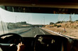 © Javier Pardina/Stocksy - Scene of a truck driver driving on the road.