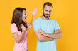 © ViDi Studio - Displeased young couple friends guy girl in blue pink t-shirts posing isolated on yellow background studio portrait. People lifestyle concept. Mock up copy space. Screaming swearing spreading hands.