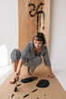 © Sergey Filimonov/Stocksy - Joyful barefoot female artist painting on craft paper
