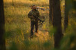 © Yakov Knyazev/Stocksy - Adult man hunting with a recurved crossbow in the forest on an autumn day.