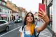 © Kike Arnaiz/Stocksy - Close up of a beautiful smiling young woman taking selfie.