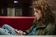 © Laika One/Stocksy - Portrait of teenage girl with curly hair and freckles indoors