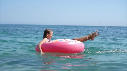 Wall Mural - Adorable girl on inflatable air mattress in the sea