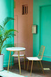 © J.  M√°rquez/Stocksy - Table and chairs on street terrace of colourful house