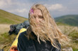© Demetr White/Stocksy - blonde girl looking at the camera and burning. hair covered the face. a flower in the hair