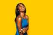 © MyMicrostock/Stocksy - Happy Black Woman posing over yellow background
