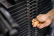 © Santi Nunez/Stocksy - Close up of a man's hand holding a weight stack.