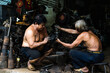 © Mauro Grigollo Photographer/Stocksy - Man working in a mechanical workshop in Vietnam