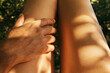 © Sonja Lekovic/Stocksy - man's hand touching woman's legs in the sun closeup