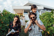 © Brat Co/Stocksy - Young Family Walking In The Vineyards