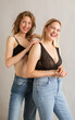 © Screen moment/Stocksy - Two young attractive women laughing. Two lovely woman in jeans and bra