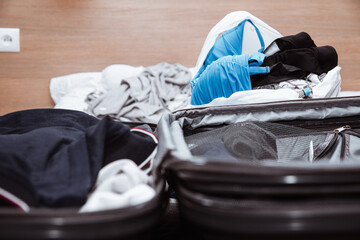 Sticker - Packing suitcases. Concept of travel and packing for a trip. A woman packs clothes into a suitcase of clothes.