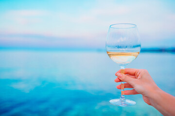 Wall Mural - Glass of white wine on tropical beach