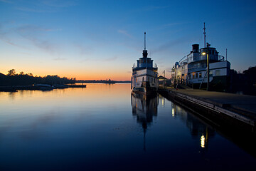  Water reflection of the steamship in the pier at twilight