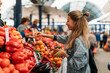 © Javier Pardina/Stocksy - Woman buying fruits and vegetables on the market.