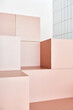 © Sergey Melnikov/Stocksy - Peach-colored cubes in room near white wall