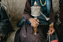 Close Up Of Old Woman Holding Prayer Wheel