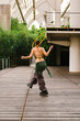 © Manu Prats/Stocksy - Hula hoop dancer walking in pavilion