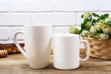 White coffee and cappuccino mug mockup with white spirea