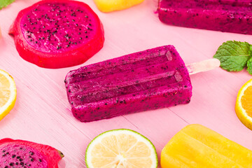 Poster - Various fresh fruit popsicles placed on wooden board background