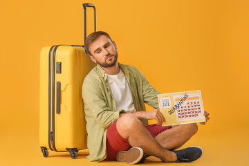 Sad man holding calendar with written word QUARANTINE against color background. Vacation concept