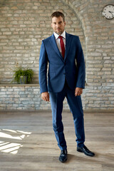 Wall Mural - Full length of confident businessman in the office.