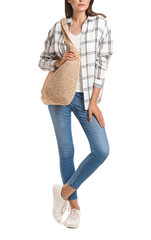 Beautiful young woman with wicker bag on white background