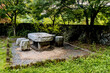 © aminkorea - Stone picnic table under shade trees