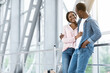 © Prostock-studio - Romantic Travel. Black Couple In Love Waiting For Flight At Airport, Hugging