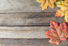 Autumn Yellow Leaves On Grey Wood Background With Copy Space