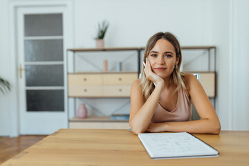 Wall Mural - Portrait of a beautiful student with paper notebook and pen.