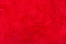 Red Matte Background Of Suede Fabric, Closeup. Velvet Texture Of Seamless Wine Leather. Felt Material Macro