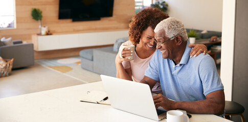 Senior African American Couple Using Laptop To Check Finances At Home