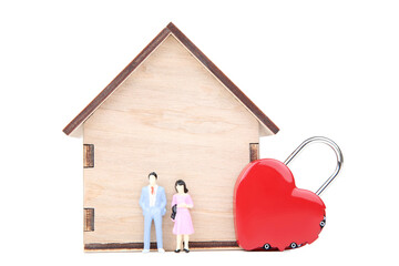 Wall Mural - Wooden house model with miniature people and padlock in shape of heart on white background