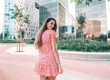 © Igor Kardasov - Beautiful young fashionable woman in sexy stylish dress posing in the modern city with skyscrapers on background