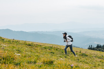 Poster - woman with backpack hiking in mountains