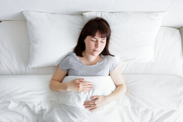 Wall Mural - top view of young woman sleeping at home