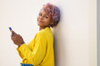 © carballo - portrait of afro american girl on the street with mobile phone