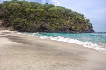 Wall Mural - Bali beach named White sand virgin Beach with turquoise sea water waves blue sky 