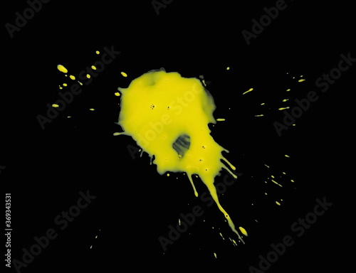 Grunge brush strokes paint. The puddle of an watercolor paint spill isolated over black background. Paint Puddle Spill. Spilled paint.