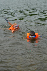 Caucasian children in a life jacket at sea