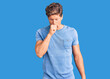 © Krakenimages.com - Young handsome man wearing casual clothes feeling unwell and coughing as symptom for cold or bronchitis. health care concept.