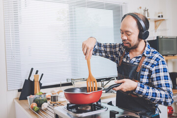 people preparing and cooking food in the home kitchen