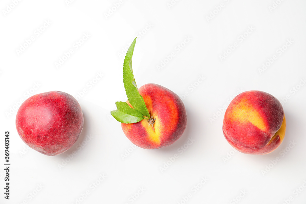 Sweet ripe peaches on white background