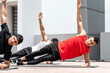 © Atstock Productions - Handsome athletic men doing side plank bodyweight workout training outdoors on building rooftop in sunlight