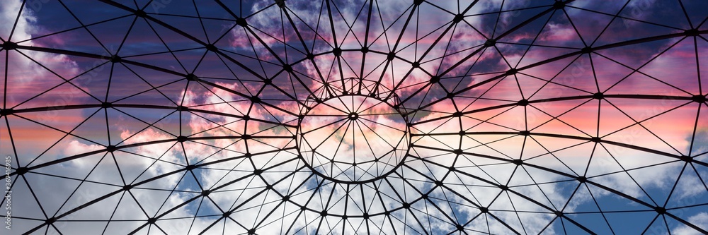 Bottom view of an iron structure with sky and clouds in the sunset. Panoramic image - obrazy, fototapety, plakaty 