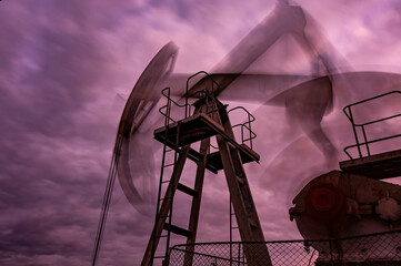 Wall Mural - Petroleum concept. Oil pump rig. Oil and gas production. Oilfield site. Pump Jack are running. Drilling derricks for fossil fuels output and crude oil production. Global crisis. War on oil prices.