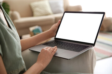 Woman using laptop at home, closeup. Space for design