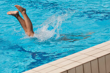 Low Section Of Woman Swimming In Pool