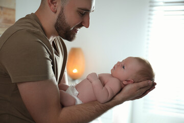 Canvas Print - Father with his newborn son at home